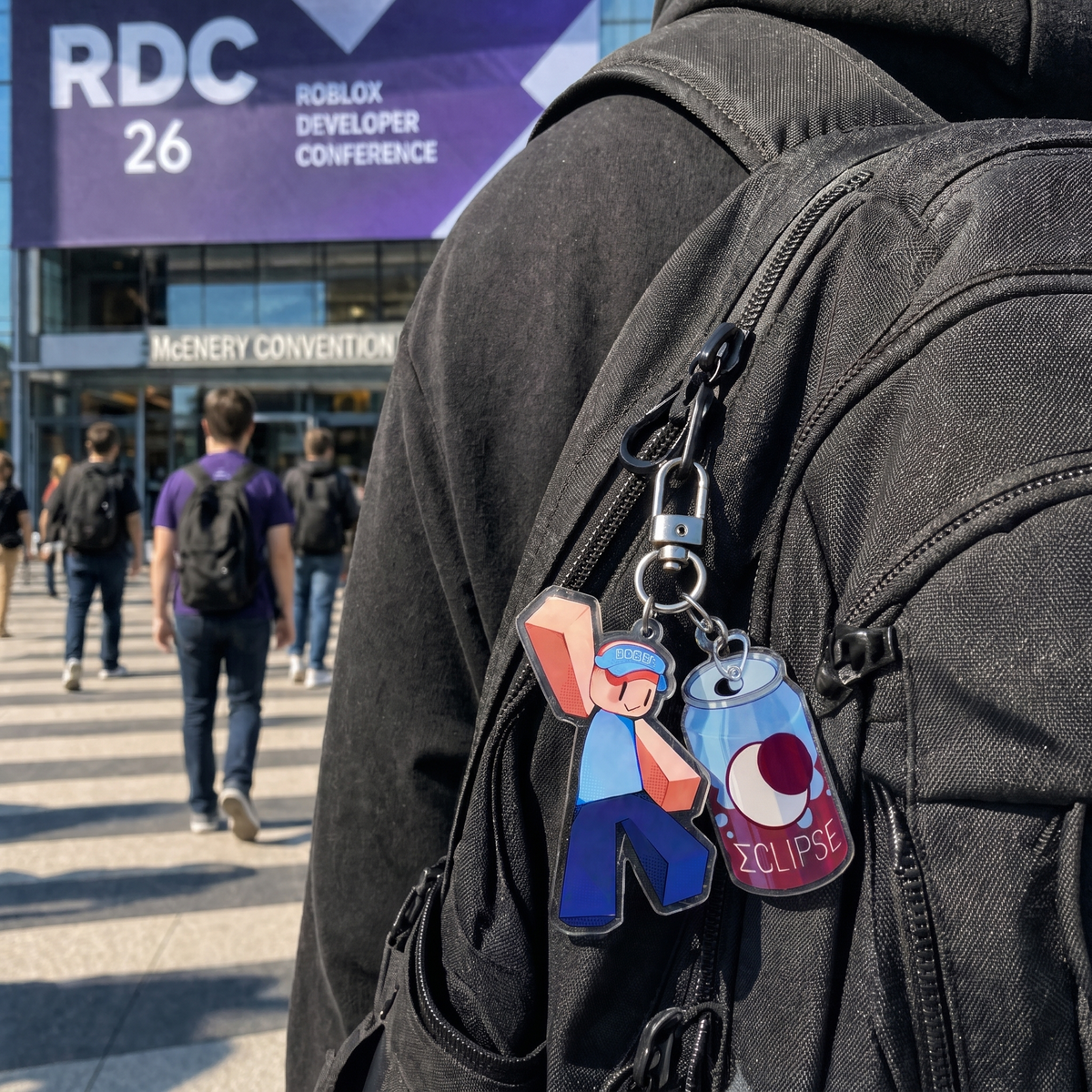 BOBO and Eclipse keychains clipped to a backpack